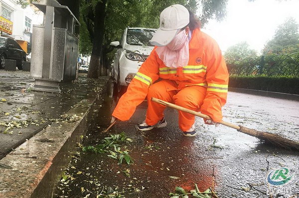 图为清洁工人清理下水道7月17日,我区再次迎来强降雨天气,区环卫中心